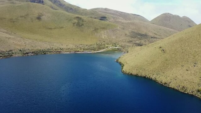 Aerial View of Mojanda Lake in Ecuador near Otavalo during a hike, blue water and green mountain