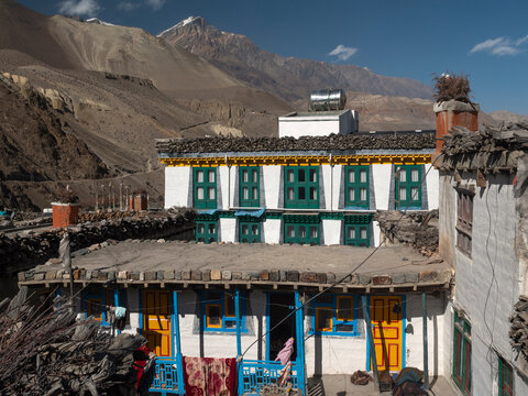 Kagbeni, Annapurna Circuit, Nepal. Colourful house with aluminium water tank and rugs hanging to dry. Upper Mustang in the background.