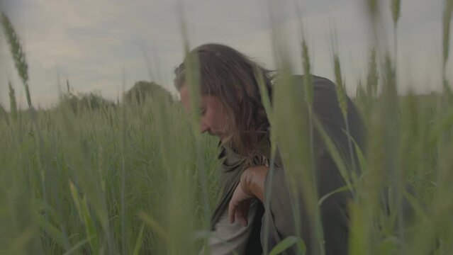 Portrait of a medieval man in a field at a picnic. A man thanks God before eat