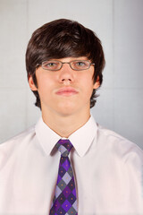 passport type picture of a young man with glasses