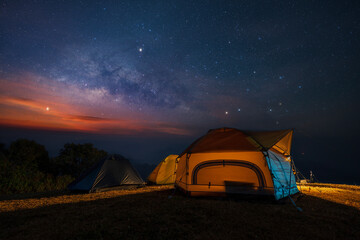 Milky way over tent locating on mountain view between the hiking route to Doi pui ko, Mae hong son,...