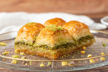 Turkish pistachio baklava. Turkish cuisine delicacies. Baklava on wood background. close up