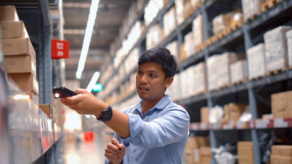 Man worker checking products with tablet in warehouse.	