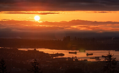 Developed city with industrial and residential buildings. Clouds in Background. Vancouver, British Columbia, Canada. Sunrise Sky