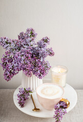 Naturals soy candle, cup with cappuccino, spring flowers lilac, woman's day