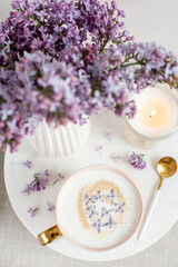 Naturals soy candle, cup with cappuccino, spring flowers lilac, woman's day
