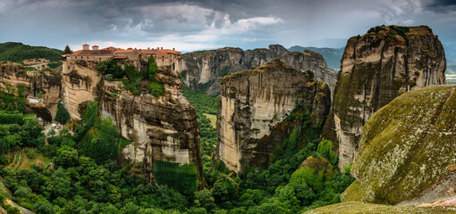 Amazing panoramic landscape of monastery on a rock. The Great Monastery of Varlaam is an Eastern Orthodox monastery. Meteora monastery complex. Thessaly. Greece. UNESCO World Heritage List.