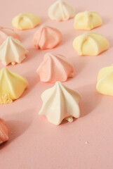 Colorful Sugar merengues on a pink background 