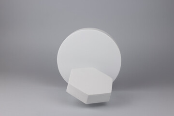 Flying empty white podiums on light grey background. Mock up stand for product presentation.  Minimal levitation concept.
