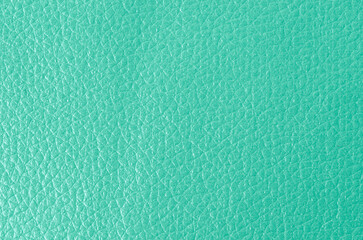 The Texture of genuine grainy leather of light mint green color for wallpaper or banner design. Fashionable modern background, copy space