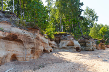 Obraz premium Veczemju klintis (Veczemju cliffs) on Baltic sea near Tuja, Latvia in summer season. Beautiful sea shore with limestone and sand caves