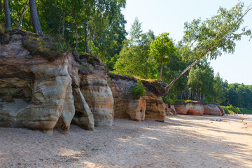 Obraz premium Veczemju klintis (Veczemju cliffs) on Baltic sea near Tuja, Latvia in summer season. Beautiful sea shore with limestone and sand caves