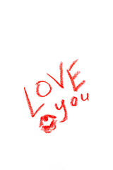 The inscription " love you" made with lipstick on a white background. lettering love you