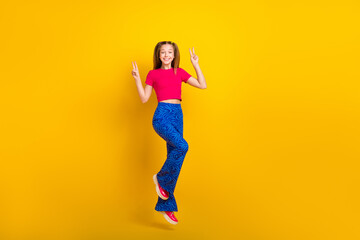 Fototapeta na wymiar Photo of cheerful funky crazy lady wear stylish outfit have fun hand demonstrate v-sign empty space isolated on yellow color background