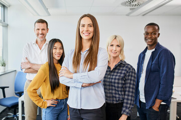 Female leader concept. Portrait of businesswoman standing with group of startup colleagues in office