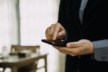 Mature businessman using a digital tablet to discuss information with a younger colleague in a modern business lounge