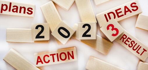 Action plan for 2023. Cubes with text 2023, plans, ideas, action ,result. Development for success...