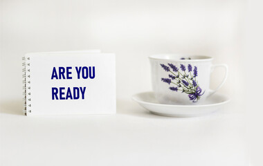 ARE YOU READY text on notebook with coffee on the wooden background