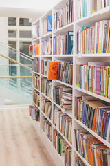 shelves with books in library or university, school. bright magazines for reading, recreation and education. scientific campus for working on diploma, term paper, writing creative articles