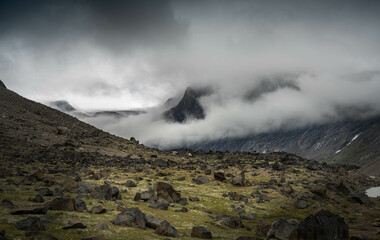 Arctic valley of Akshayuk Pass, Baffin Island, Canada on a cloudy day. Dramatic arctic landscape with Mt. Breidablik and Mt. Thor.