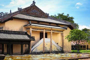 long pong with lotus next to classical vietnamese architecture in chinese style in hue royal palace
