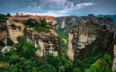 Fototapeta na wymiar Amazing panoramic landscape of monastery on a rock. The Great Monastery of Varlaam is an Eastern Orthodox monastery. Meteora monastery complex. Thessaly. Greece. UNESCO World Heritage List.