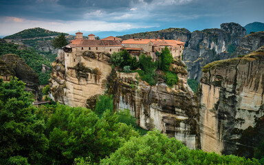 Amazing panoramic landscape of monastery on a rock. The Great Monastery of Varlaam is an Eastern Orthodox monastery. Meteora monastery complex. Thessaly. Greece. UNESCO World Heritage List.