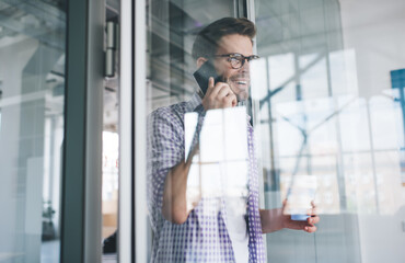 Business man talking on smartphone in office