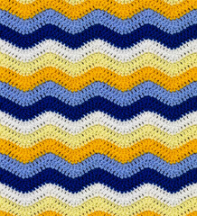Seamless knitted pattern in the form of zigzags crocheted with threads of contrasting colors. Acrylic baby yarn. African style.