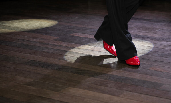 Close-up of a male tango dancer's legs in a ballroom