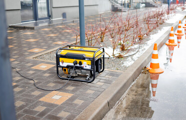 Power supply generator placed on street sidewalk. outdoor diesel power generator in Ukraine.