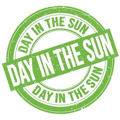 DAY IN THE SUN text written on green round stamp sign