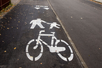 Obraz premium Horizontal white warning signs for bicycles, pedestrians and vehicles. Asphalt.