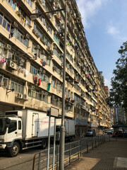 View of a typical multi-story condominium in an Asian neighborhood with air conditioners and laundry outside the window