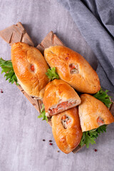 Rasstegai buns with red fish, rice and roasted onion. Russian yeast dough bakery product. Top view - 567774198
