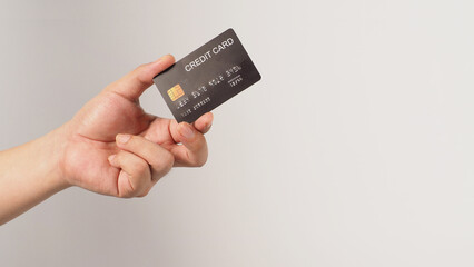 Hand is hold black credit card isolated on white background....