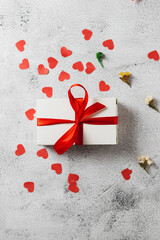 White box with red ribbon and hearts
