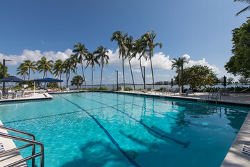 Large commercial swimming pool overlooking ocean.