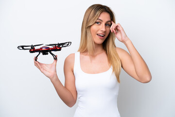 Young Uruguayan woman holding a drone isolated on white background thinking an idea