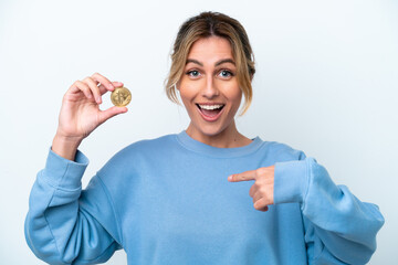 Young Uruguayan woman holding a Bitcoin isolated on white background with surprise facial expression