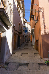 Old street with stairs and ramps for cars in a small town in Catalonia