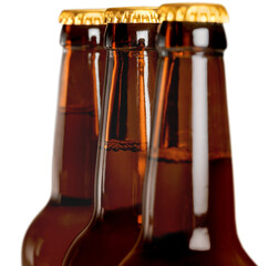 Upper part of three beer bottles