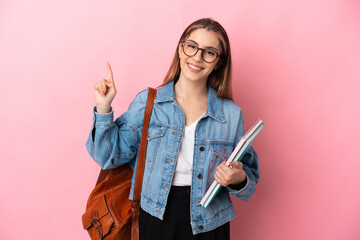 Young caucasian student woman isolated on pink background showing and lifting a finger in sign of the best