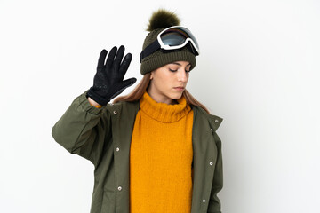 Skier caucasian woman with snowboarding glasses isolated on white background making stop gesture and disappointed
