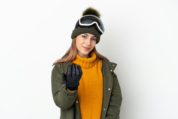 Skier caucasian woman with snowboarding glasses isolated on white background inviting to come with hand. Happy that you came