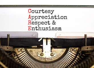 CARE symbol. Concept words CARE courtesy appreciation respect and enthusiasm on typewriter on beautiful white background. Business CARE courtesy appreciation respect enthusiasm concept. Copy space.