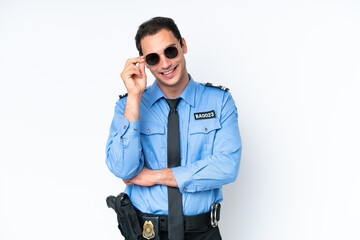 Young police caucasian man isolated on white background with glasses and happy