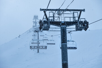 Chairlift with high metal poles to climb skiers to the top of the mountain, Grandvalira, Andorra,