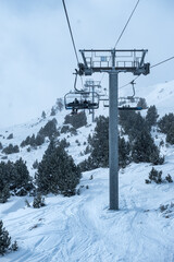 Chairlift with high metal poles to climb skiers to the top of the mountain, Grandvalira, Andorra,