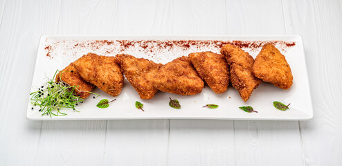 Homemade chicken nuggets on white background